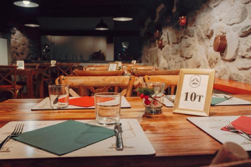 a wooden table with a number sign on it at Locanda La Brenva - Estella Hotel Collection & Experience in Courmayeur