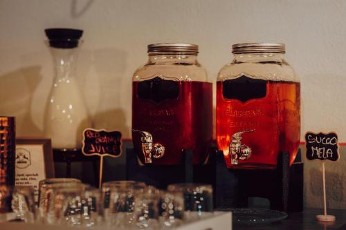 two mason jars filled with drinks on a table at Locanda La Brenva - Estella Hotel Collection & Experience in Courmayeur