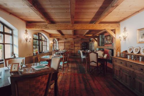 a restaurant with wooden ceilings and tables and chairs at Locanda La Brenva - Estella Hotel Collection & Experience in Courmayeur