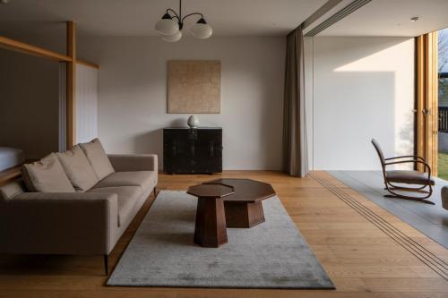 a living room with a couch and a table at 歓宿縁 eshikoto in Eiheiji