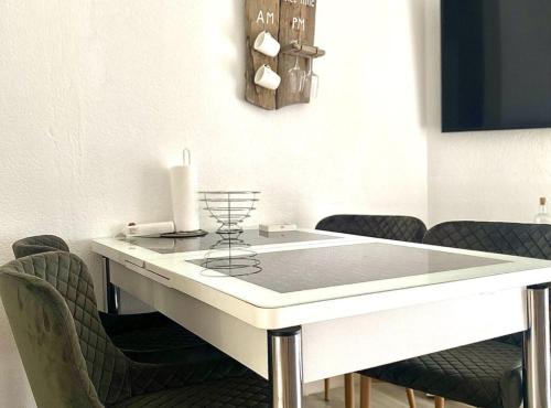 a dining room with a white table and chairs at Luxury Lovran Apartments with Swimming Pool in Lovran