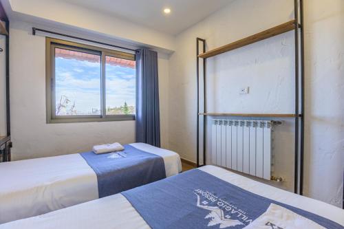 a bedroom with two beds and a window at Villagio Resort in Zaarour in Zaarour
