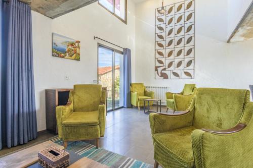 a living room with chairs and a fireplace at Villagio Resort in Zaarour in Zaarour