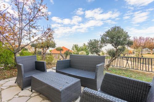 a patio with wicker chairs and a table at Villagio Resort in Zaarour in Zaarour