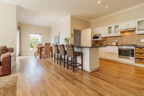 a kitchen and dining room with a table and chairs at Manor One Kingswood Golf Estate in George