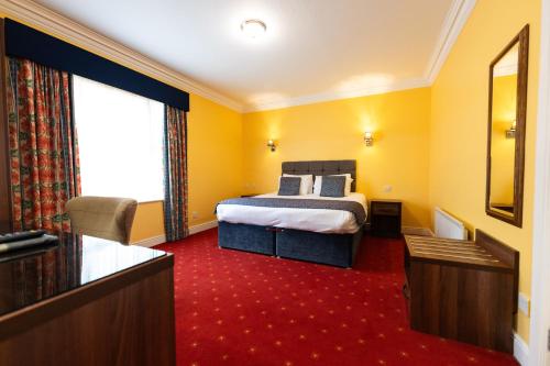 a hotel room with a bed and a large window at Celtic Royal Hotel & Spa in Caernarfon