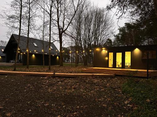 a small house with lights on the side of it at Storm Villas in Sturmai