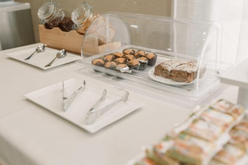 a white table with a plate of food on it at Aparthotel Villas La Manga in La Manga del Mar Menor