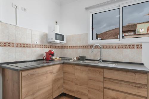 a kitchen with a sink and a window at One life one dream Gran Canaria in Carrizal