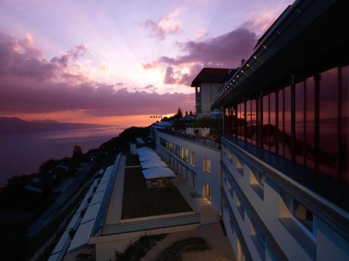 a view of a building with a sunset in the background at Le Mirador Resort & Spa in Vevey