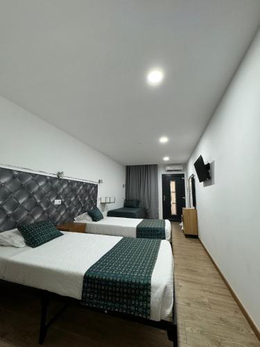 Postel nebo postele na pokoji v ubytování Hotel Rubi