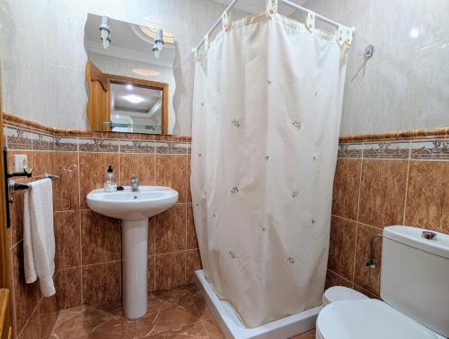 a bathroom with a shower curtain and a sink at CHC - Apartamento Los Silos Tulipanes 2 in Los Silos