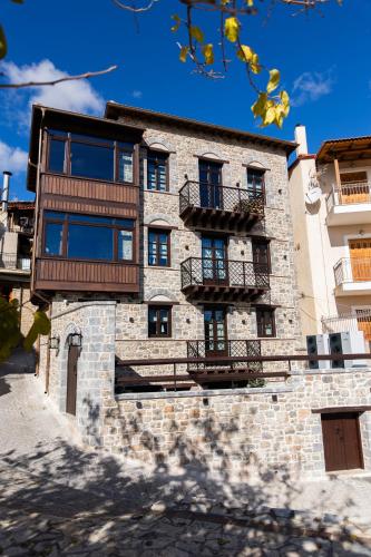 a stone building with balconies on the side of it at Maison Michelangelo in Arachova