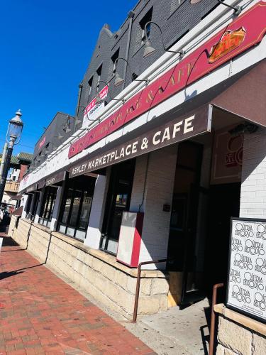 a building with a sign for a market and cafe at 41 Montrose Master Bedroom in Newark