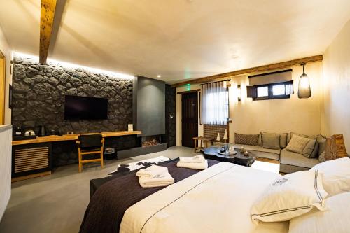 a hotel room with a large bed and a couch at Maison Michelangelo in Arachova