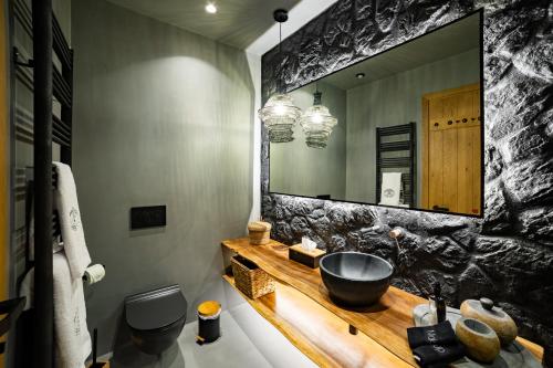 a bathroom with a sink and a large mirror at Maison Michelangelo in Arachova