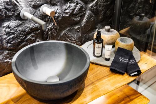 a bowl sink on a wooden counter with a bottle of wine at Maison Michelangelo in Arachova