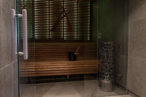 a glass shower in a bathroom with a window at Best Western Hotel Arctic Eden in Kiruna