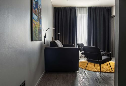 a living room with two chairs and a couch at Best Western Hotel Arctic Eden in Kiruna