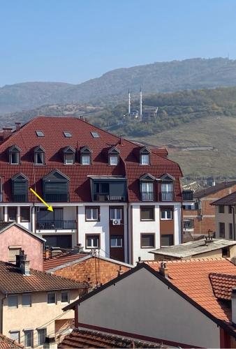 a group of buildings with red roofs in a city at Apartment Prizreni-Free Private Parking in Prizren