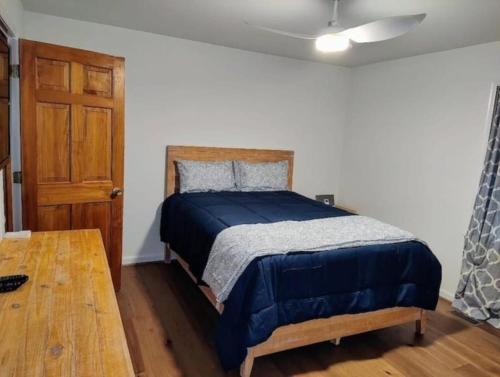 a bedroom with a bed and a wooden table at Cozy and Comfy with Lake Access in Mineral