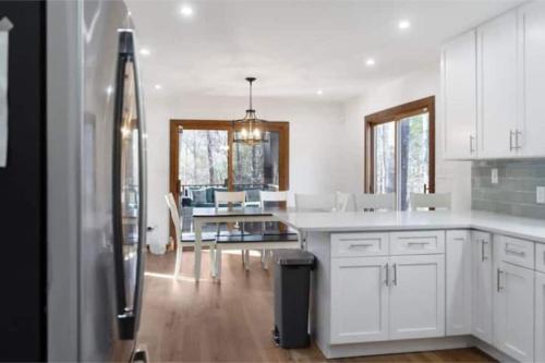 a kitchen with a refrigerator and a dining room at Cozy and Comfy with Lake Access in Mineral