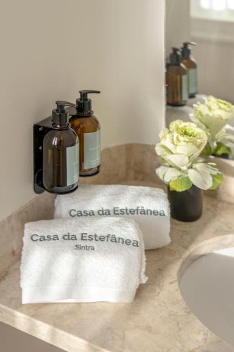 a bathroom with two towels on a sink at Casa da Estefânea in Sintra