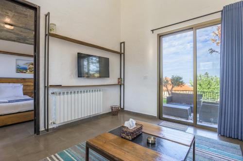 a living room with a bed and a table at Villagio Resort in Zaarour in Zaarour