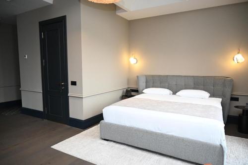 a bedroom with a bed and a black door at Hotel Retro in Batumi