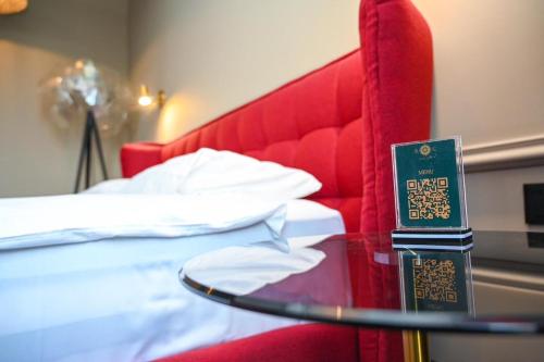 a table with a sign on it next to a bed at Hotel Retro in Batumi