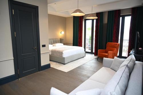 a hotel room with a bed and a couch at Hotel Retro in Batumi