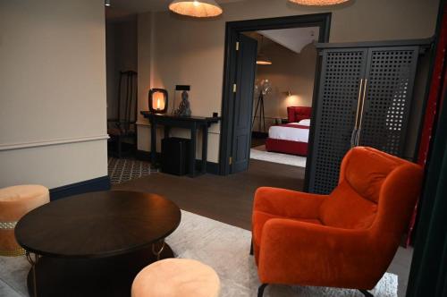 a room with a bed and a table and a chair at Hotel Retro in Batumi