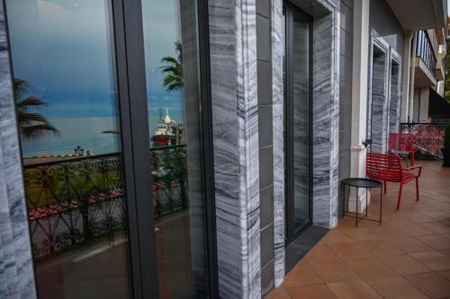 a balcony with a view of the ocean from a building at Hotel Retro in Batumi