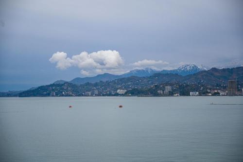 a large body of water with a city and mountains at Hotel Retro in Batumi