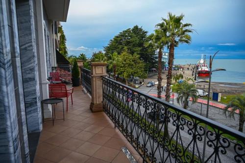a balcony of a building with a view of the ocean at Hotel Retro in Batumi