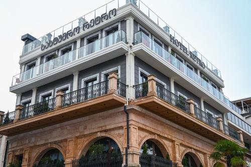 a building with a sign on top of it at Hotel Retro in Batumi