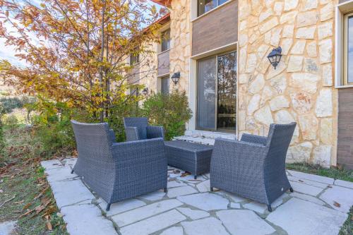 a group of chairs sitting on a stone patio at Villagio Resort in Zaarour in Zaarour