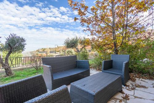 two chairs and a bench on a patio at Villagio Resort in Zaarour in Zaarour