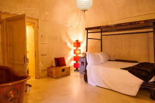 a bedroom with a large bed in a room at Casa Baladin camere di Charme e Agronidi dell'Open Garden in Piozzo