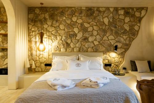 a bedroom with a large bed with towels on it at Maison Michelangelo in Arachova