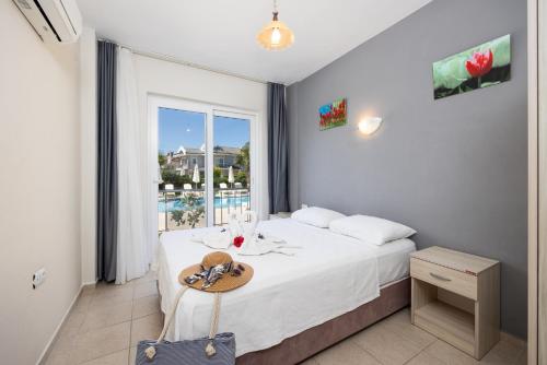 a bedroom with a bed with a table and a window at Safak Oasis Hotel in Dalyan