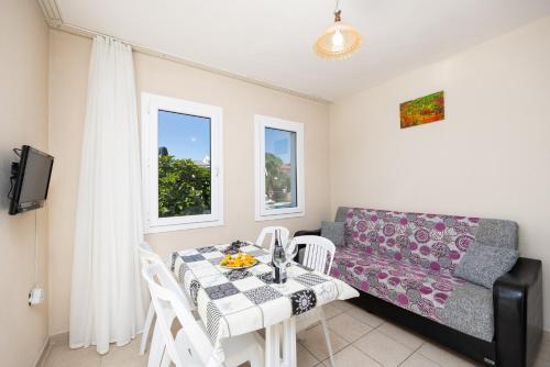 a living room with a table and a couch at Safak Oasis Hotel in Dalyan