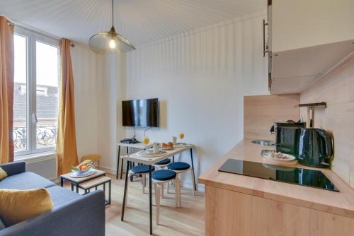 a kitchen and living room with a couch and a table at Bluestay 141 - Superb apartment in Bagnolet