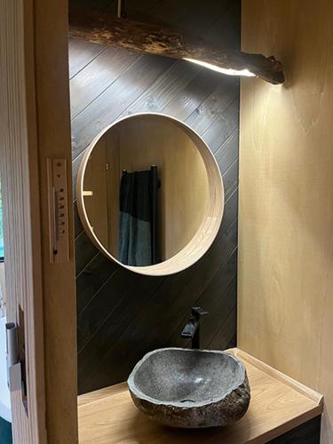 a bathroom with a stone sink and a mirror at Syrok Magasflash in Sirok
