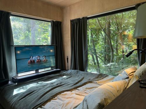 a bedroom with a bed and a flat screen tv at Syrok Magasflash in Sirok