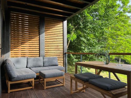 a patio with a table and chairs and a table at Syrok Magasflash in Sirok