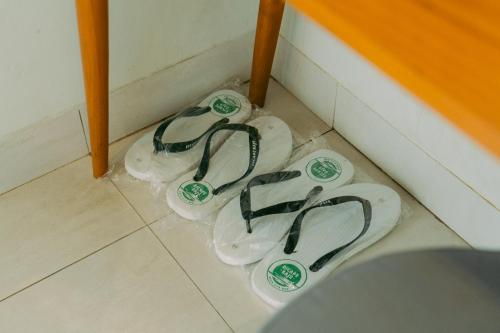 three toilets sitting in a corner of a bathroom at Escape Bajo in Labuan Bajo