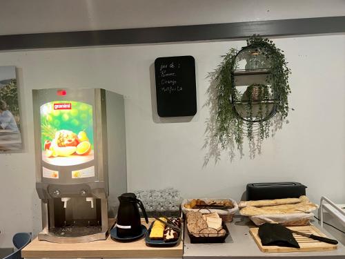 a counter with a drink dispenser on a wall at Residhotel Galerie Tatry in Bordeaux
