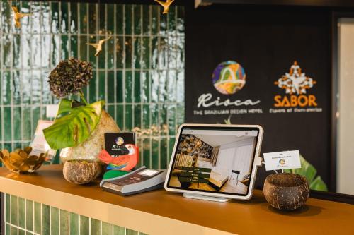 a table with a tablet sitting on top of it at Rioca Frankfurt Posto 7 in Frankfurt