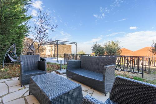 a patio with wicker chairs and a table at Villagio Resort in Zaarour in Zaarour